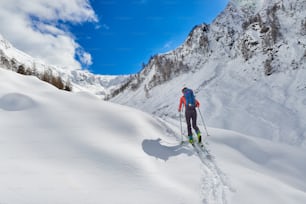 Girl makes ski mountaineering uphill alone in the alps