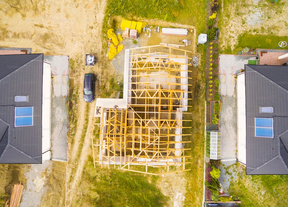 Construction site of new family house. Aerial view of area for pleasant living in suburban district. Construction industry from above.
