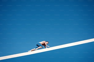 man climbing the white beam in urban scene