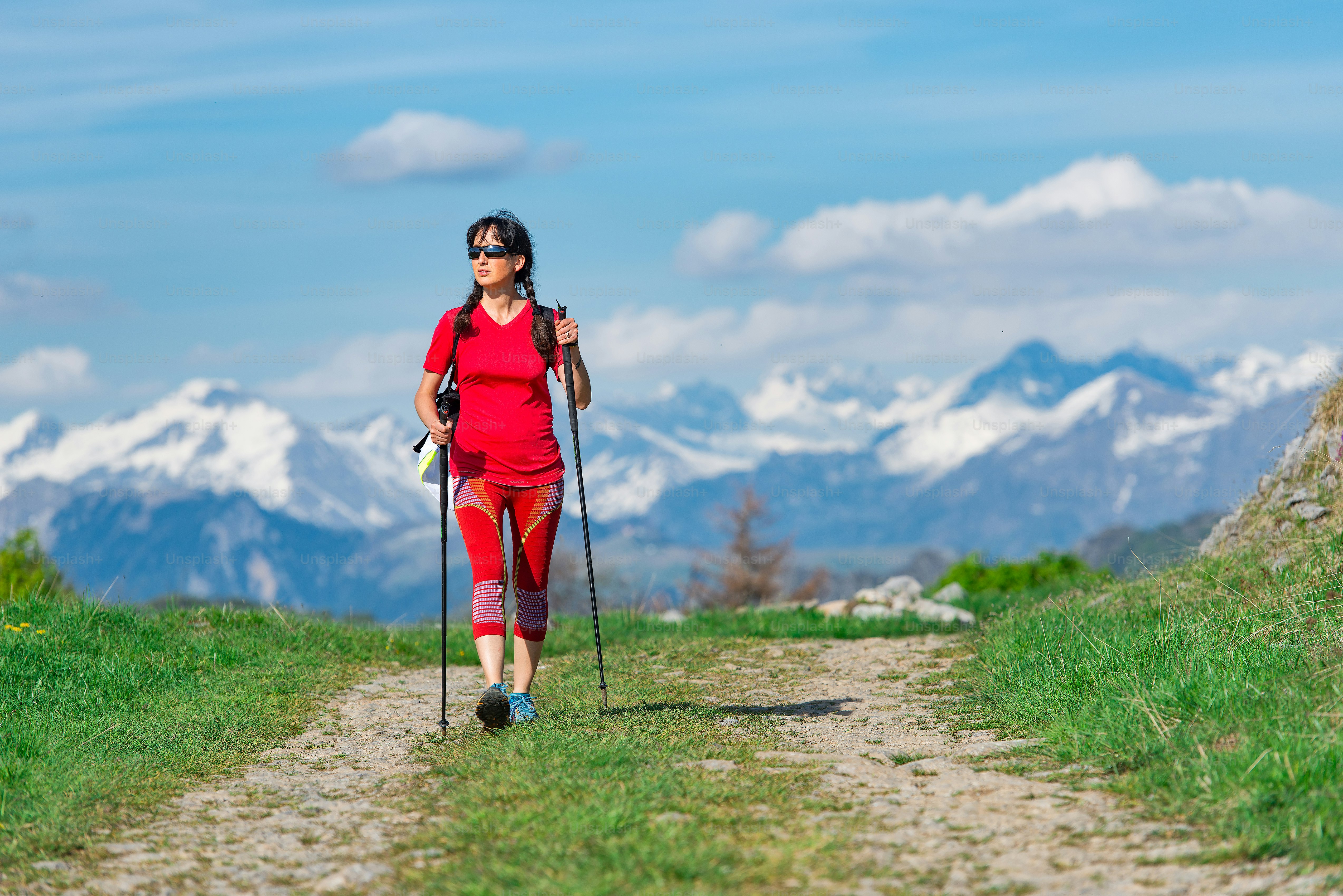 Tourist walking in the mountain road with snowy mountains far away