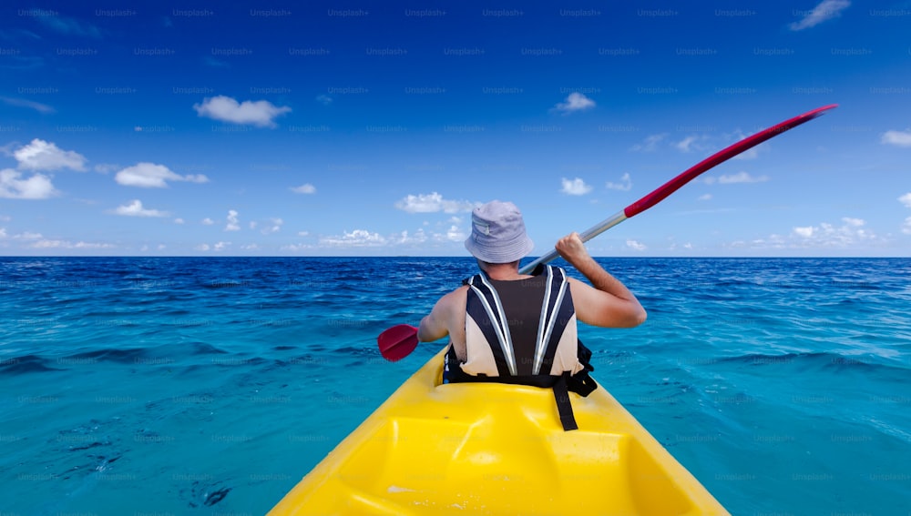 Caucasian man kayaking in sea at Maldives