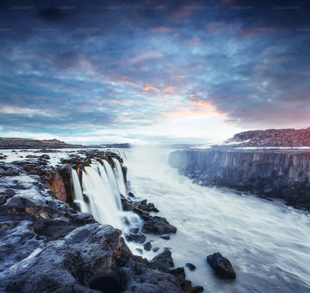 Fantastic views of Selfoss waterfall in the national park Vatnajokull. Mysterious and mystical sunset in pink - orange. Iceland