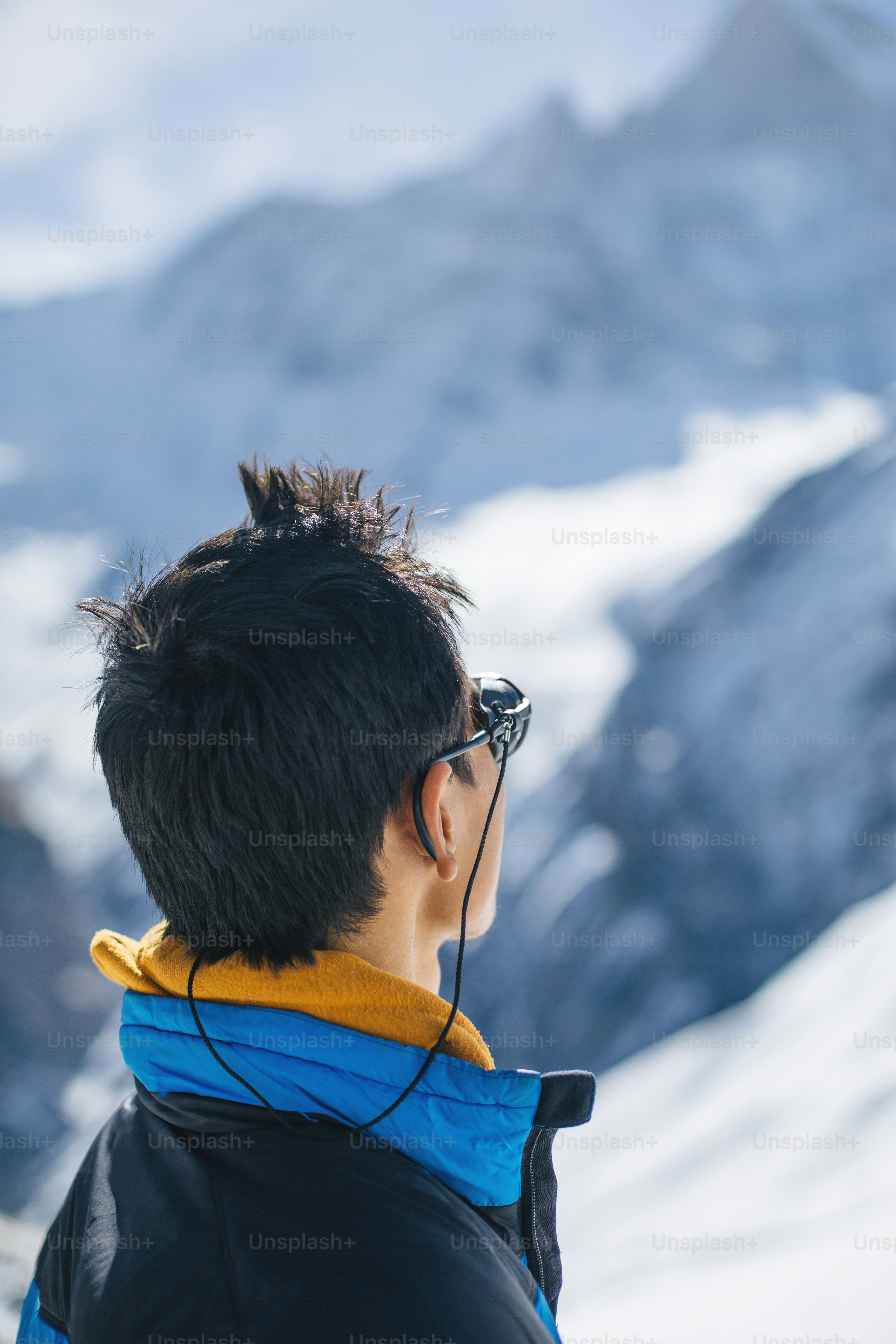 Young Sherpa looking at one of summits in the Himalaya mountain wilderness of Nepal.