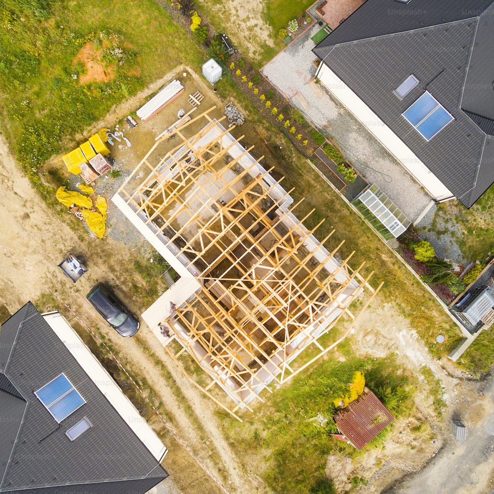 Construction site of new family house. Aerial view of area for pleasant living in suburban district. Construction industry from above.