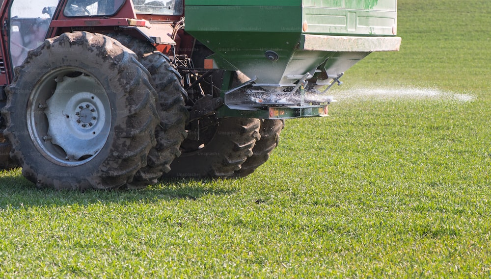 Tractor and fertilizer spreader in field