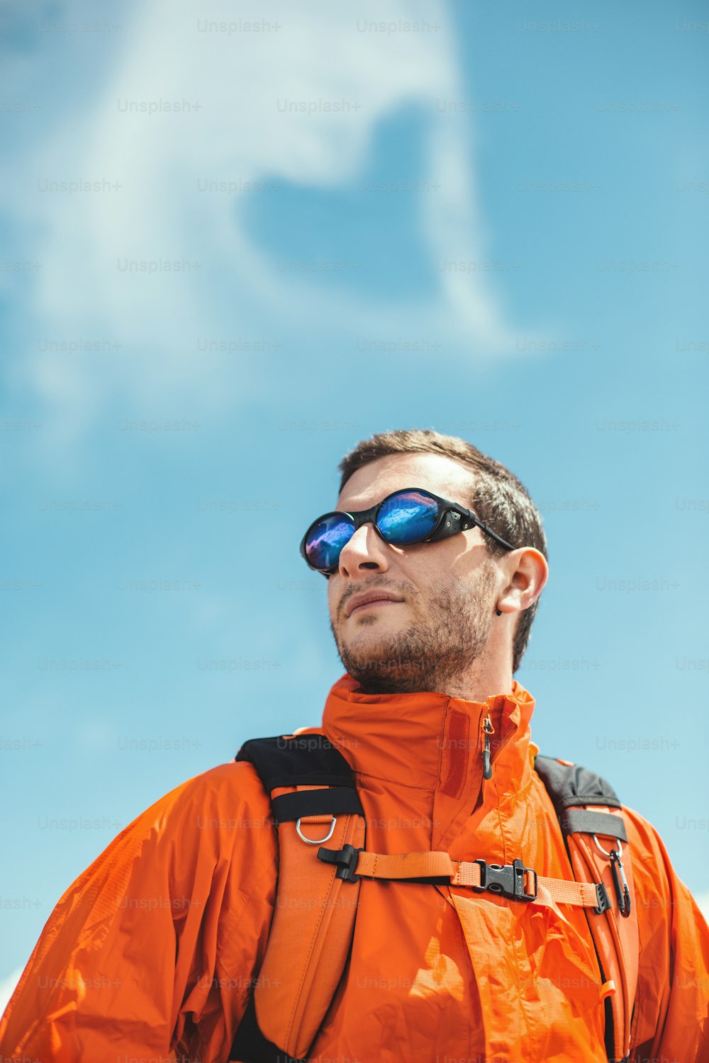 Mountaneer with heart shape cloud and mountain range in his glasses.