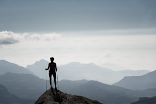 Girl on  the top of a mountain looking horizon