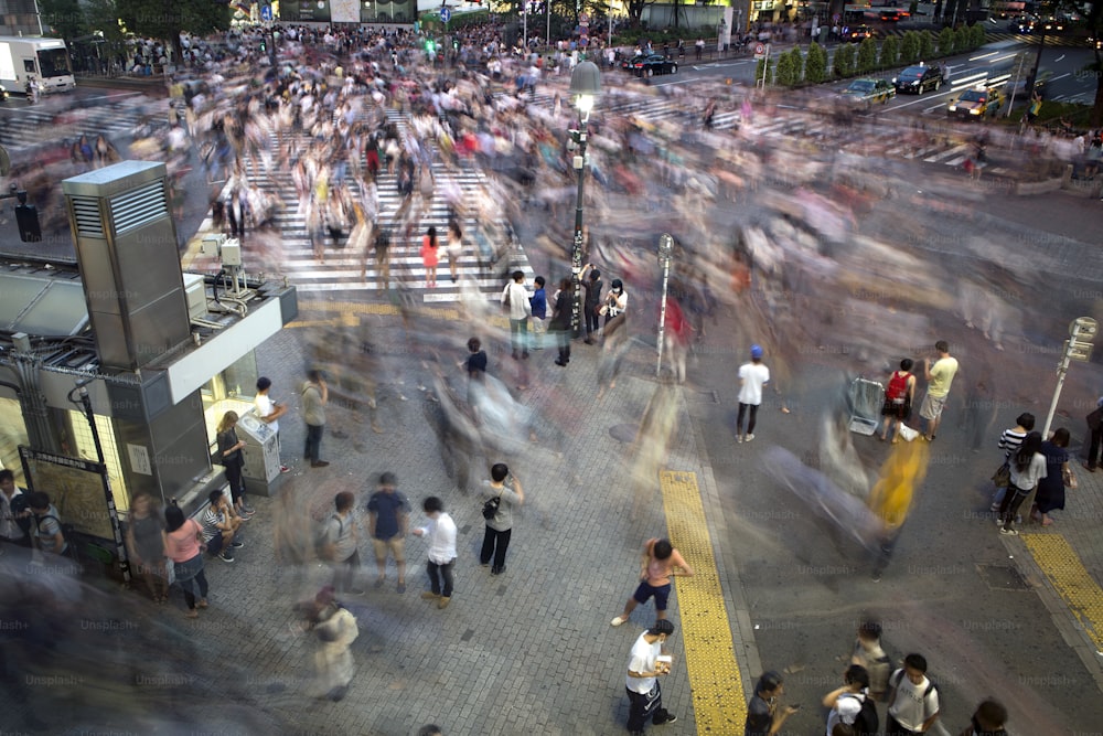 People cross the worlds busiest crossing in Shibuya in Tokyo, Japan. A long exposure was used to add movement and blur to the image.