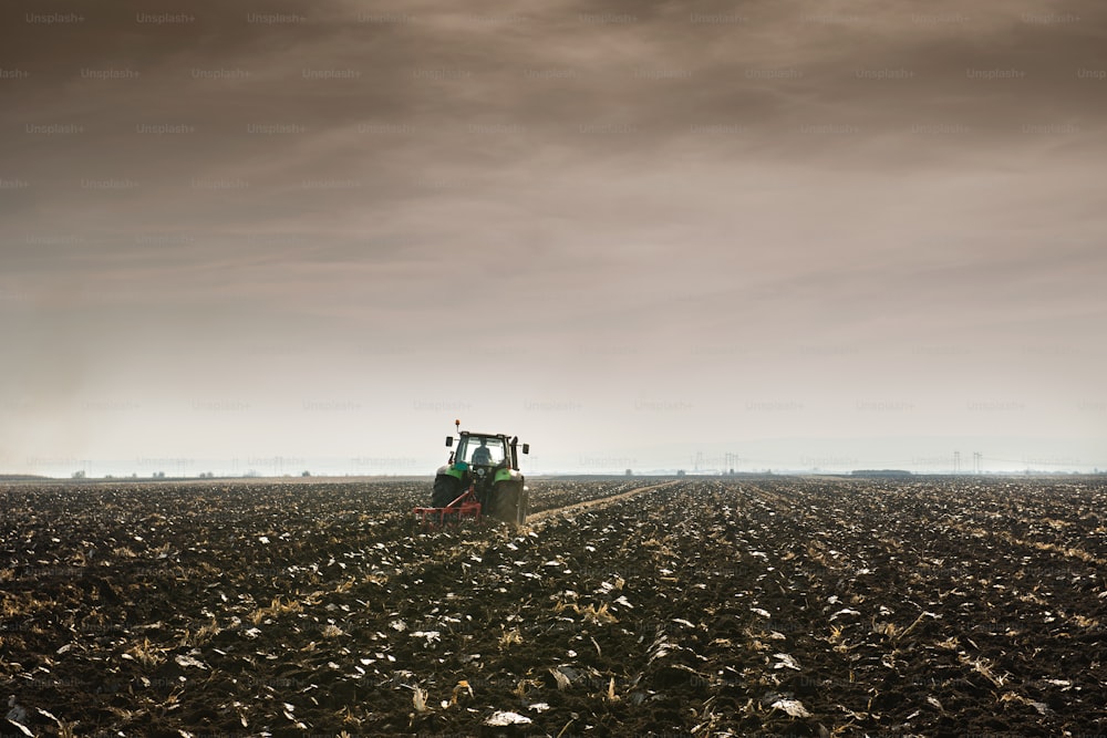 Tractor plowing field in autumn