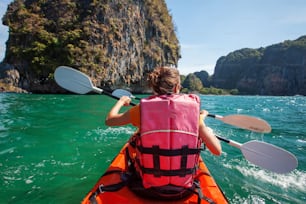 Caucasian woman is kayaking in sea at Thailand