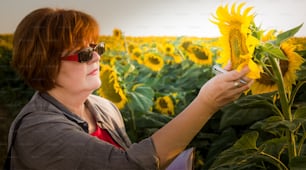 Agriculture, female farmer or agronomist in sunflower field