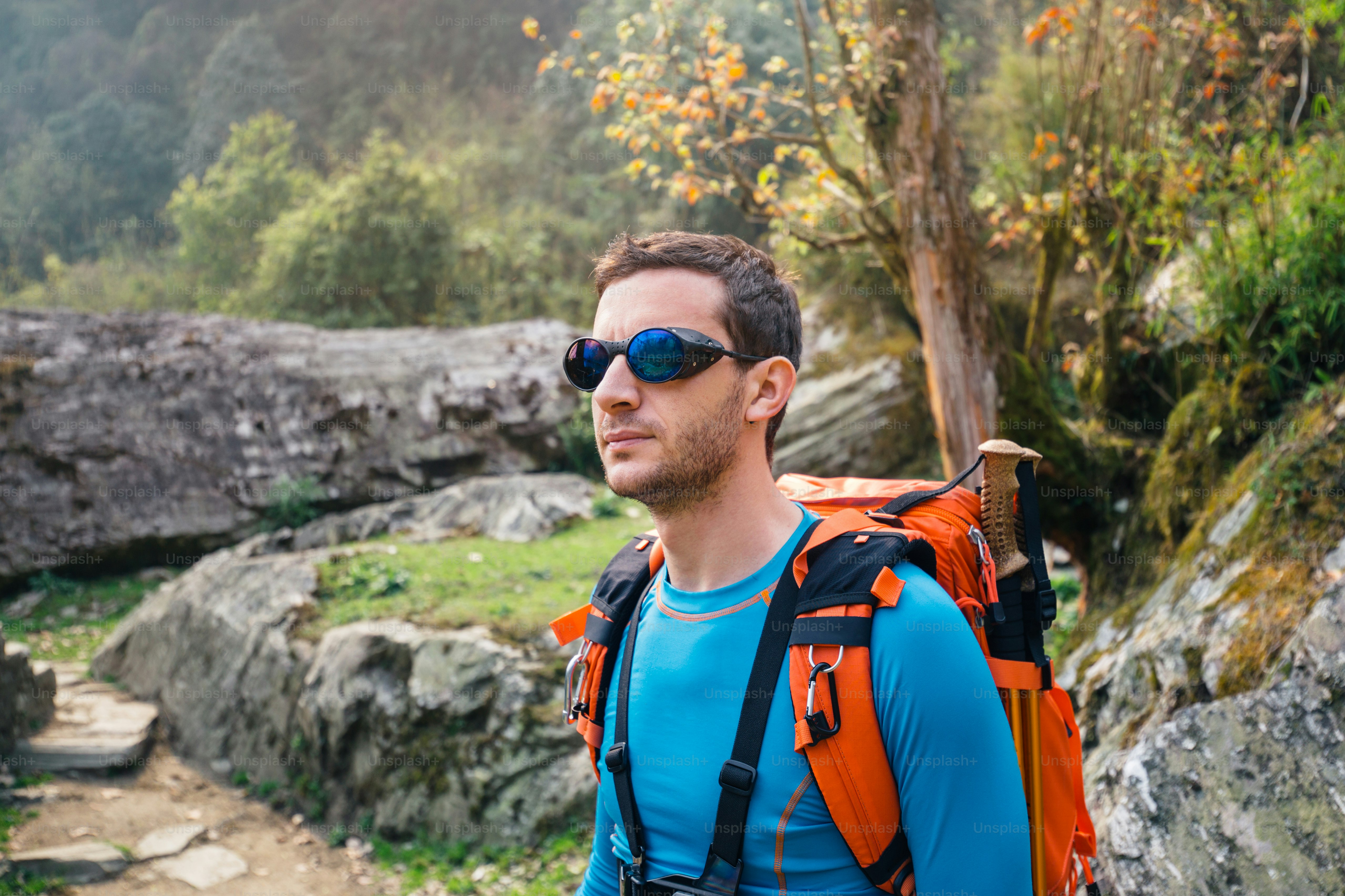 Hiker with backpack and mountaineer sunglasses.