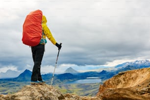 woman hiker on the trail in the Islandic mountains. Trek in National Park Landmannalaugar, Iceland