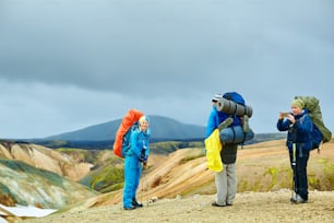 hikers on the trail in the Islandic mountains. Trek in National Park Landmannalaugar, Iceland
