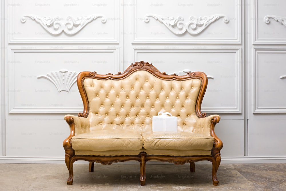 a couch sitting in front of a white wall