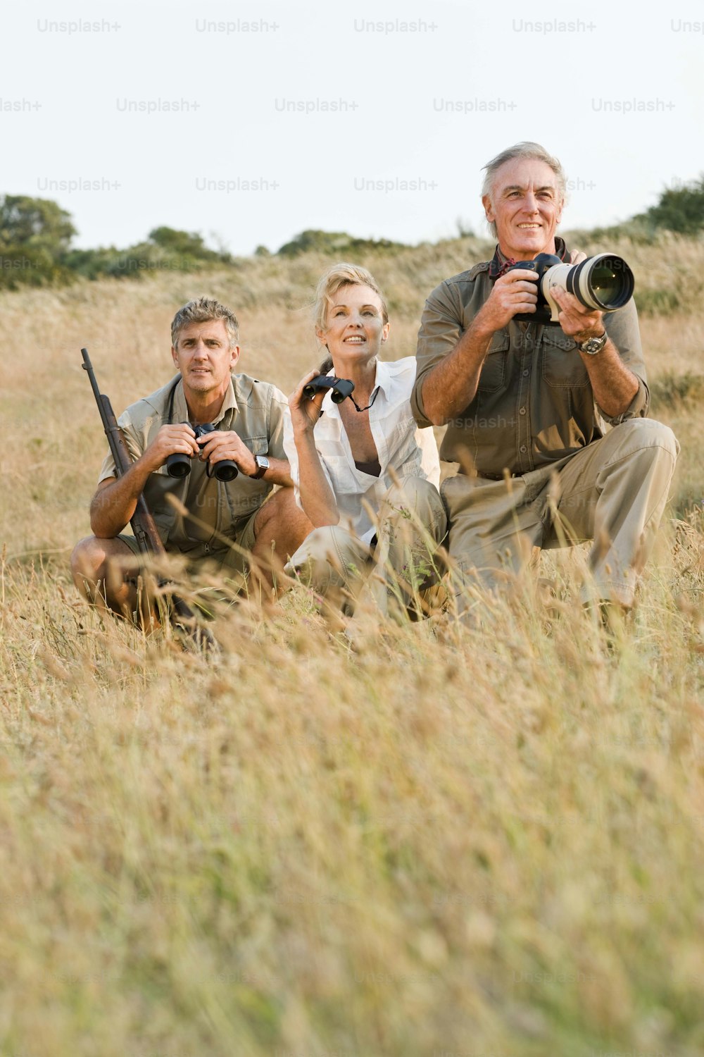 a group of people taking pictures in a field