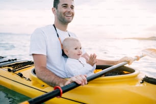 Father and son enjoy time together in kayak.