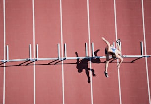 a male athlete is running on a track