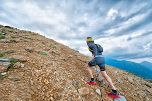 Skyrunner athlete while training for mountain trail with sticks