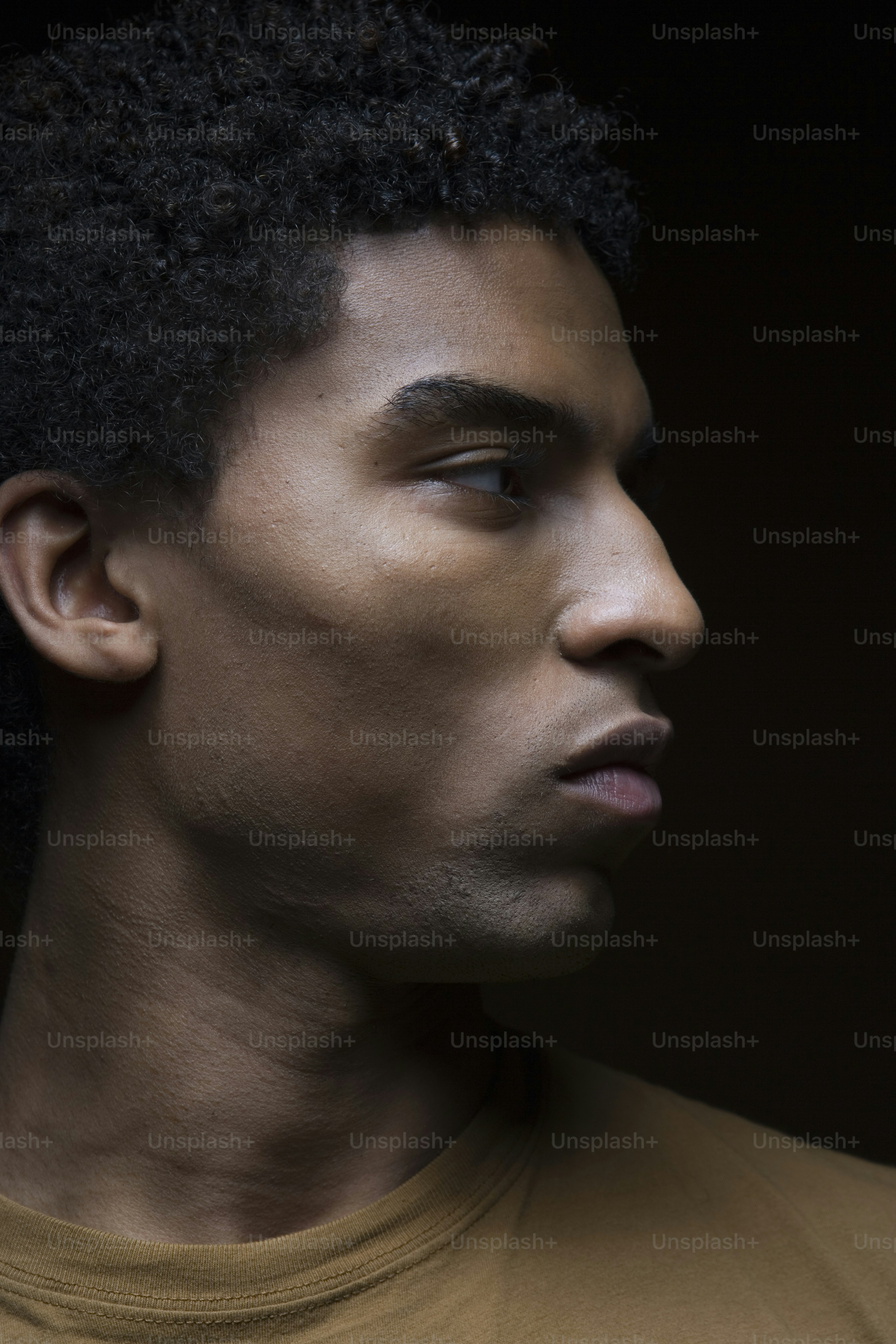 a close up of a person wearing a brown shirt