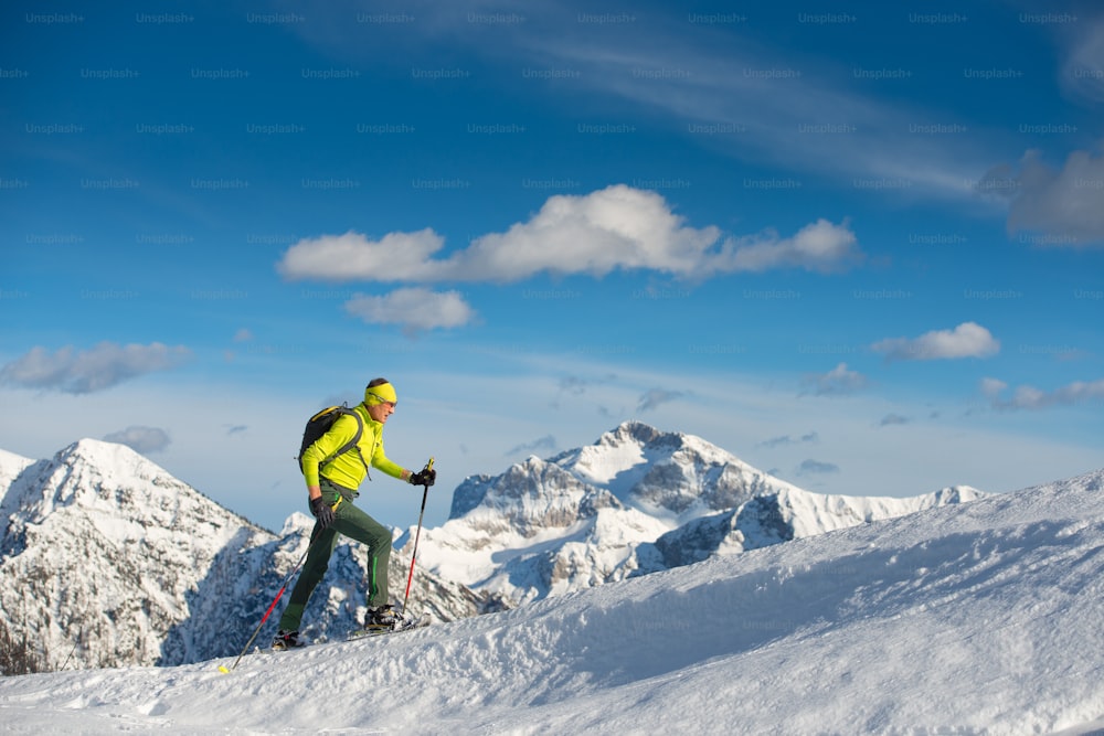 Hombre raquetas de nieve en sitio de montaña