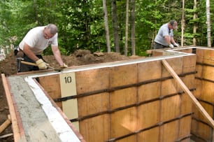 two men working on a construction project in the woods