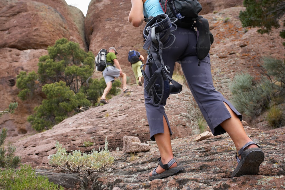 a group of people hiking up a rocky hill