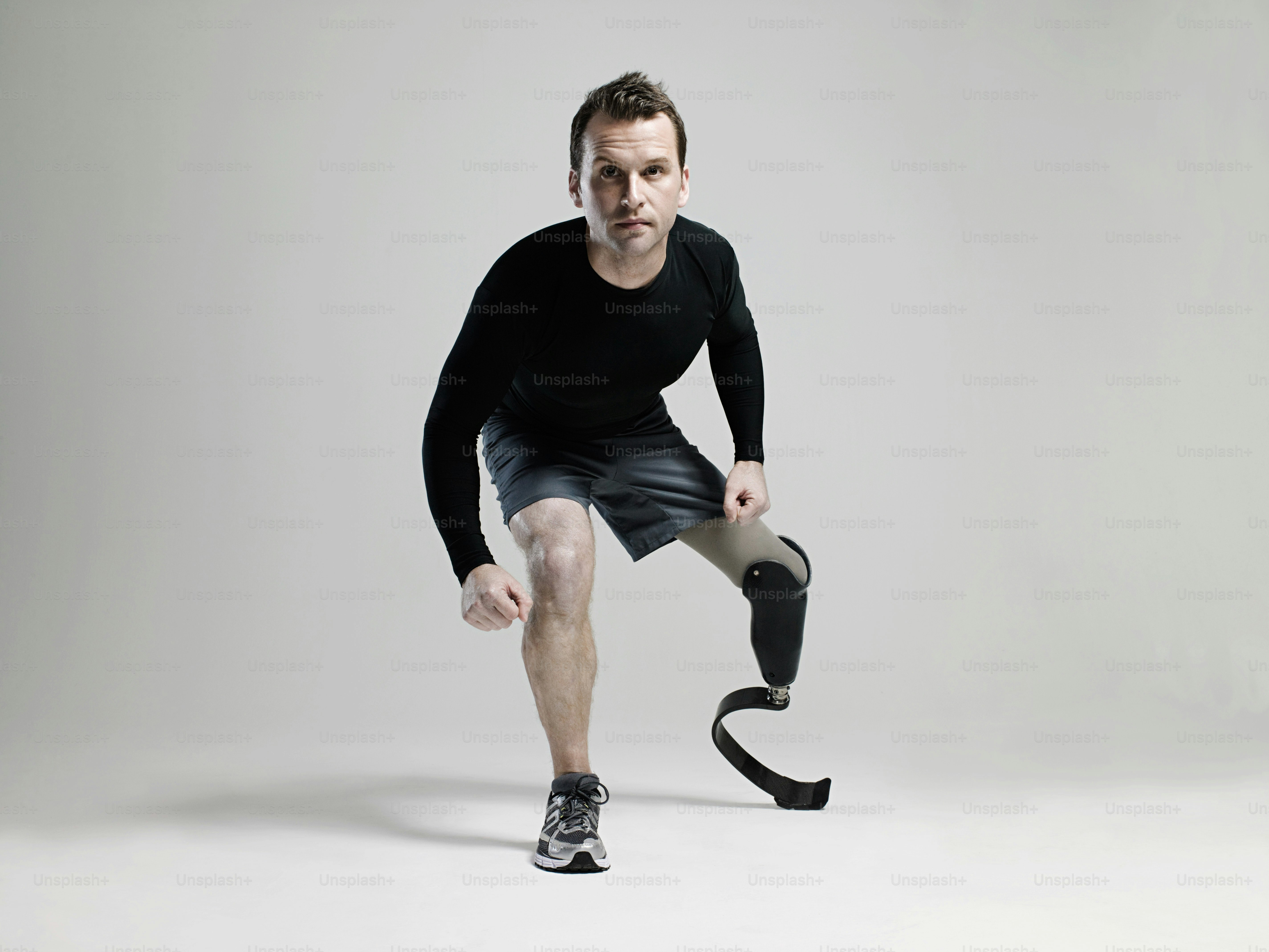 a man in black shirt and shorts holding a black object