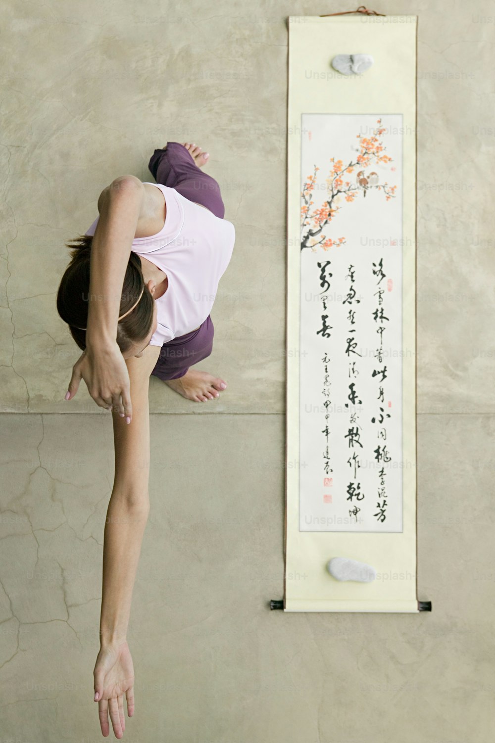 a woman is doing a handstand in front of a wall