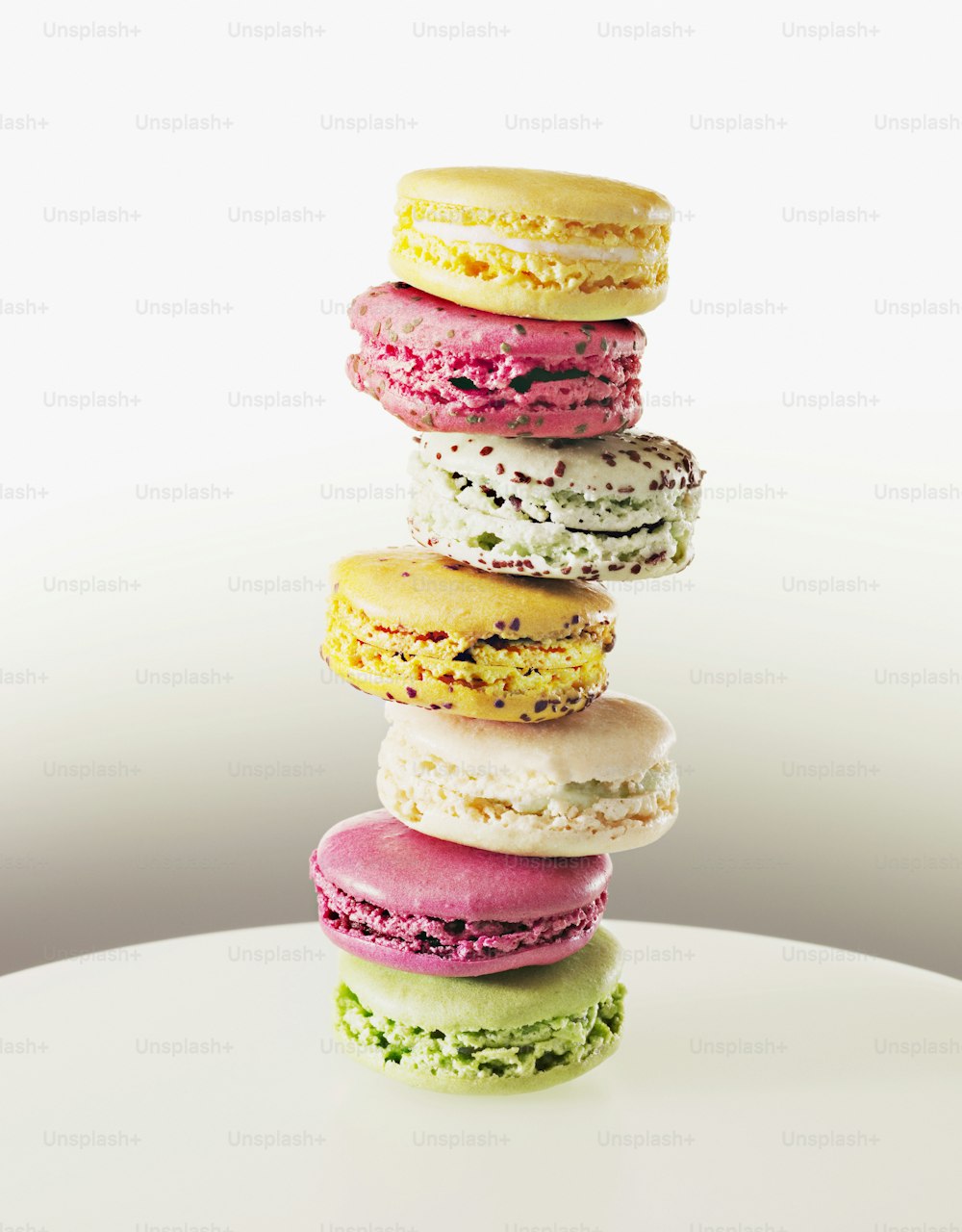 a stack of macaroons sitting on top of a white table