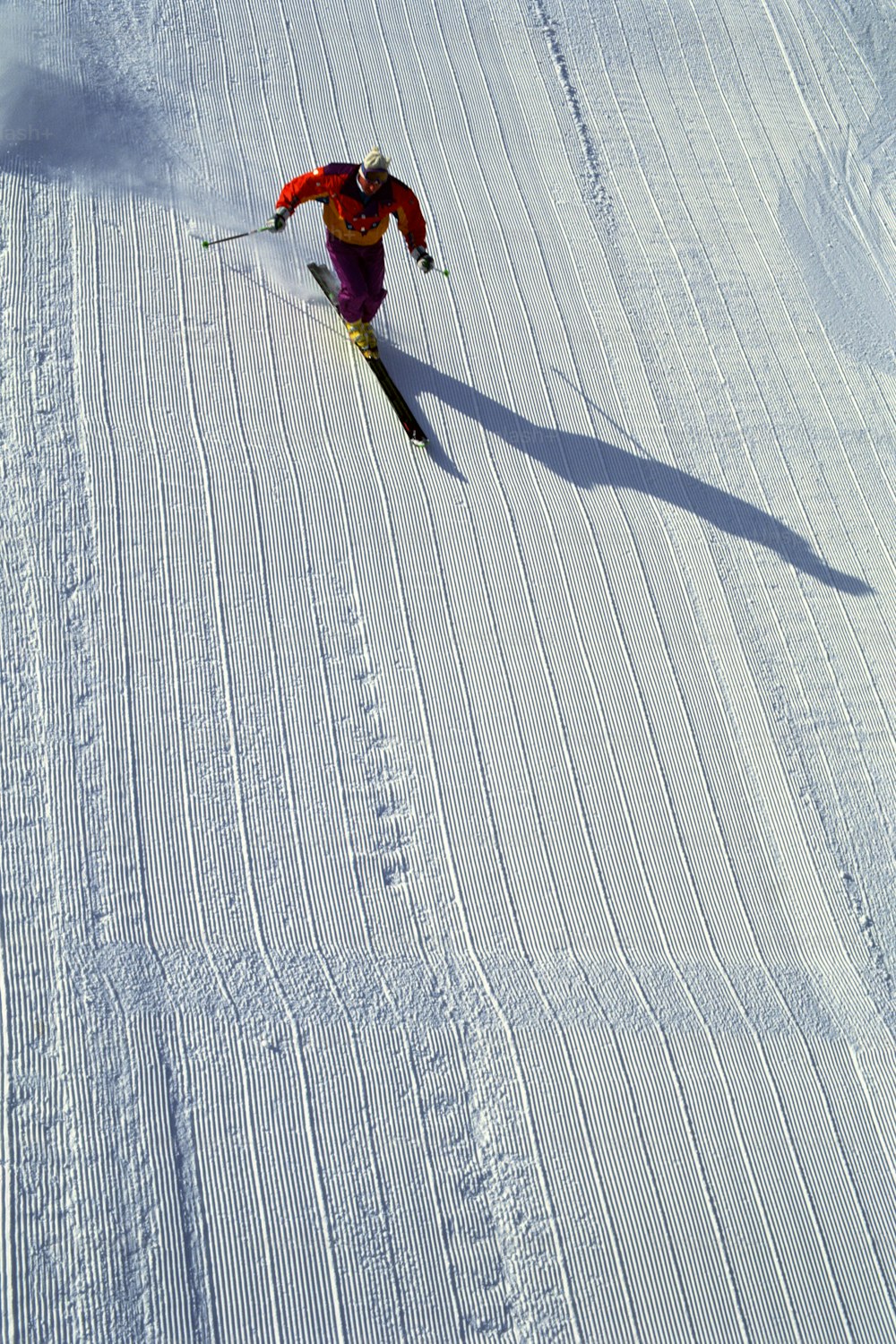 a person riding skis down a snow covered slope