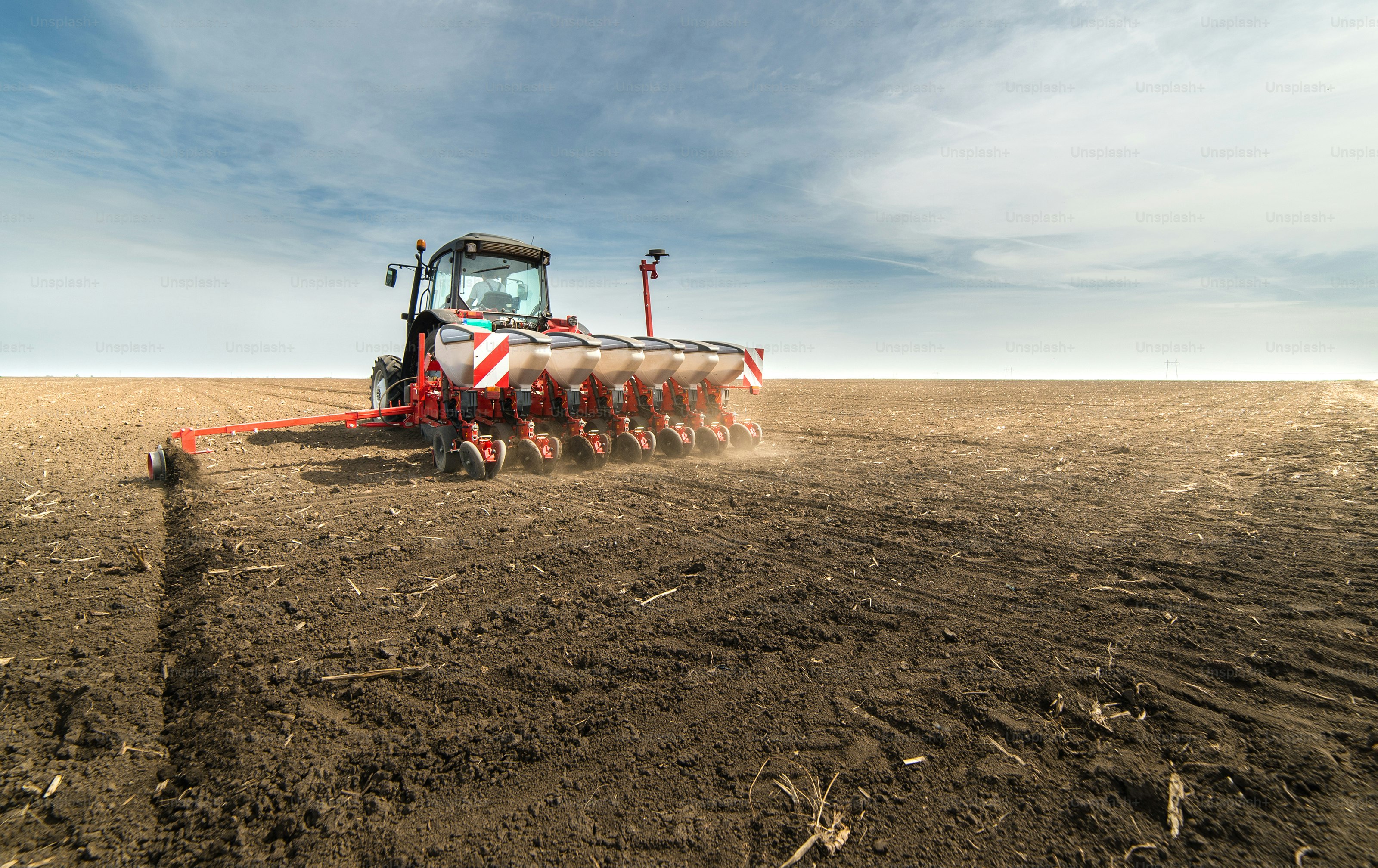 Farmer seeding crops at field