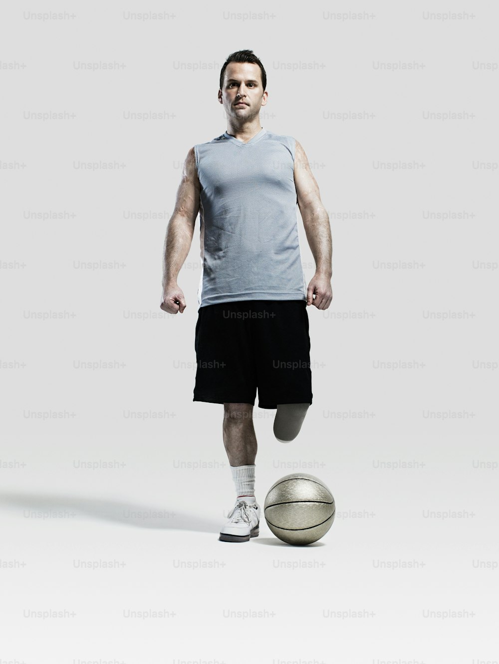 a man standing in front of a basketball