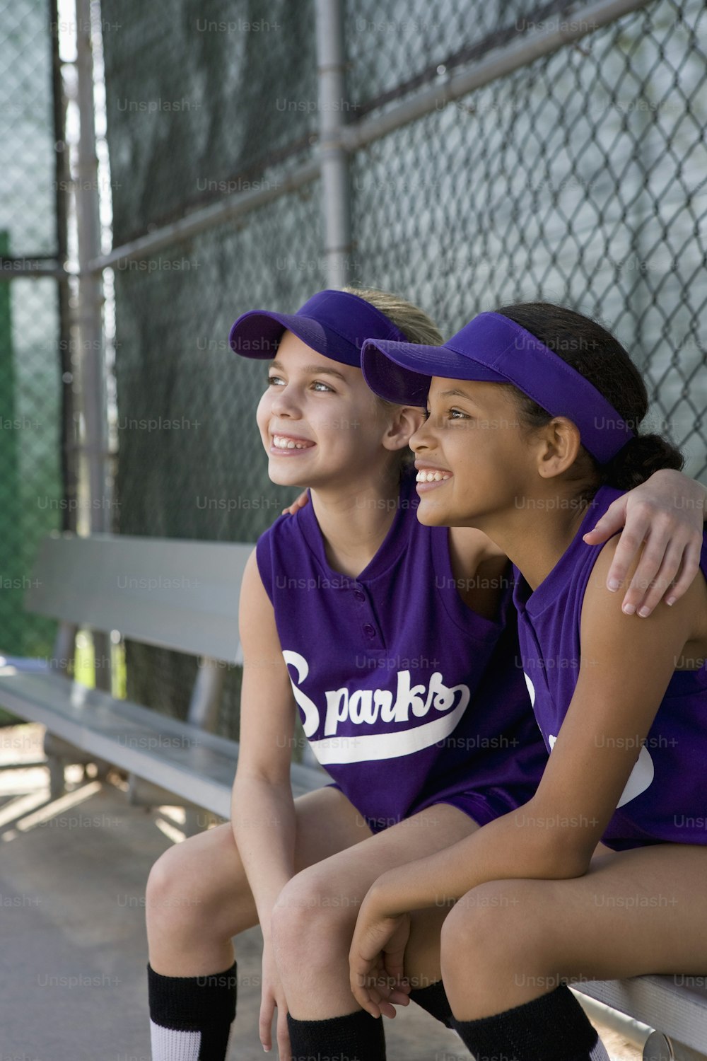 a couple of women sitting next to each other on a bench