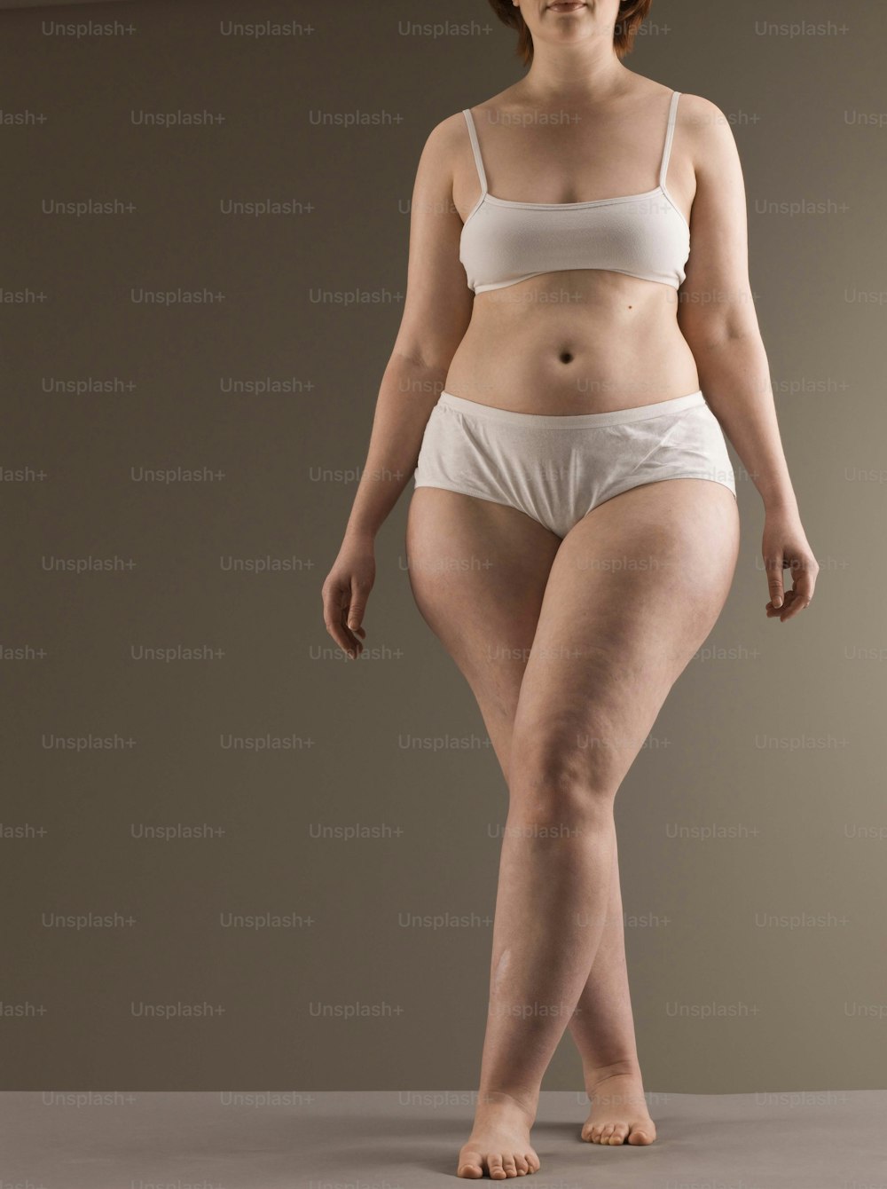 a woman in a white bikini top and panties