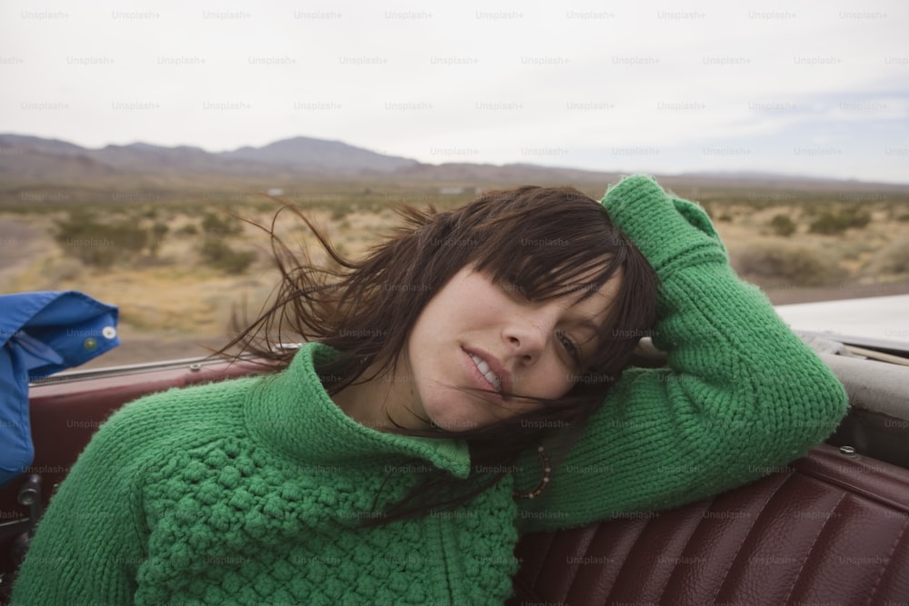 a woman sitting in the back of a car