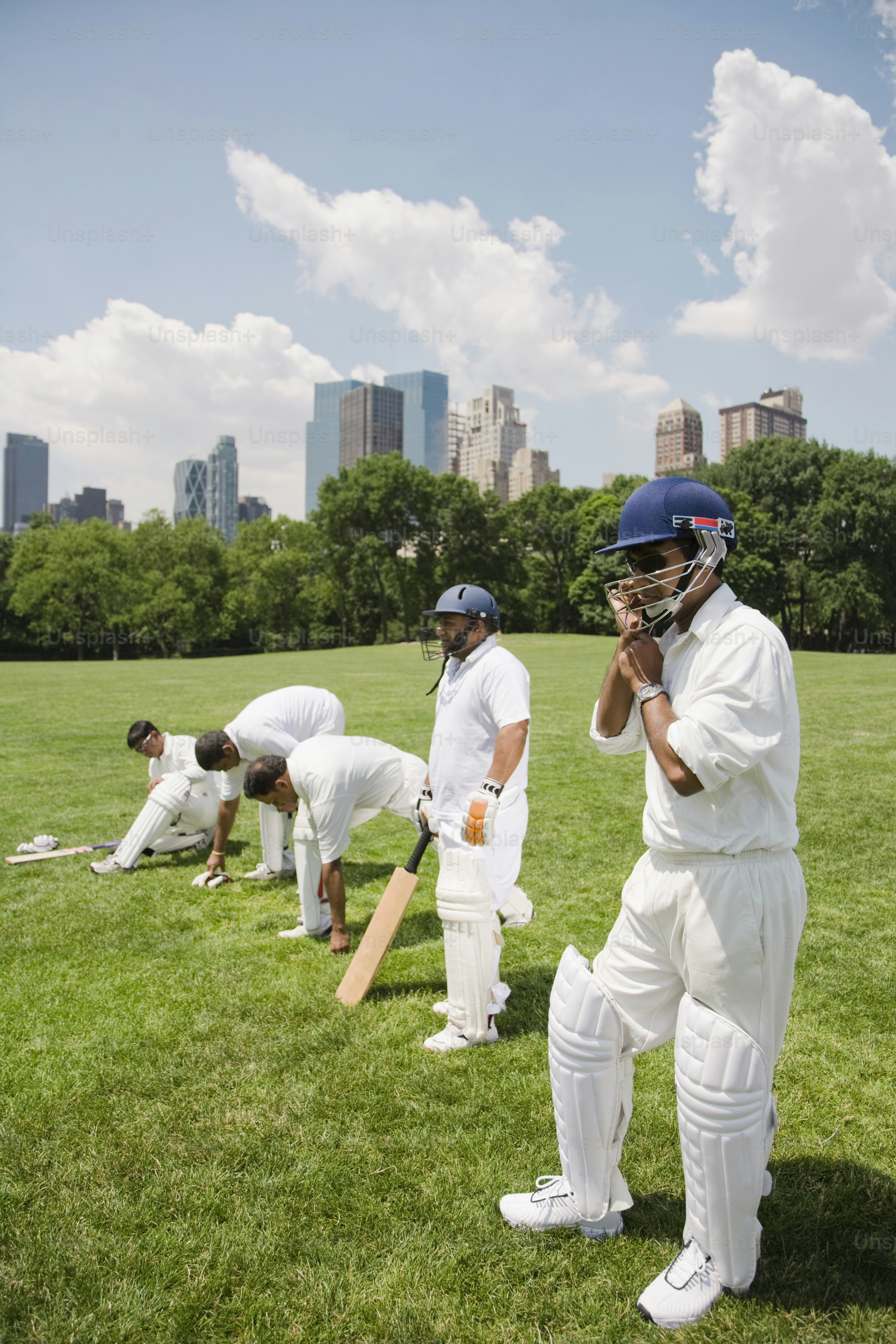 a group of men standing on top of a lush green field