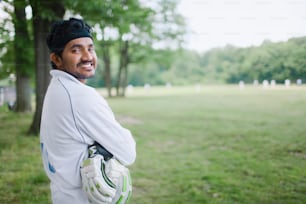 a man standing in a field with a catchers mitt