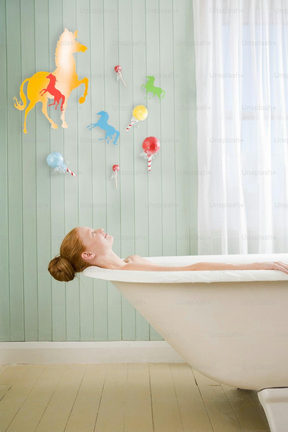 a woman laying in a bathtub in a bathroom