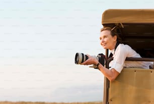 a woman taking a picture of herself in a safari vehicle