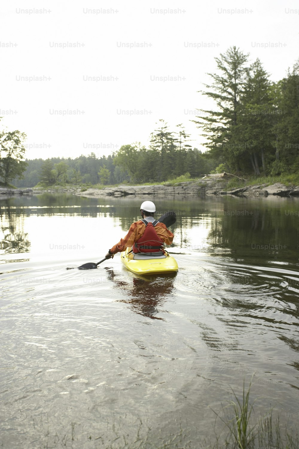 a person in a kayak paddling on a lake