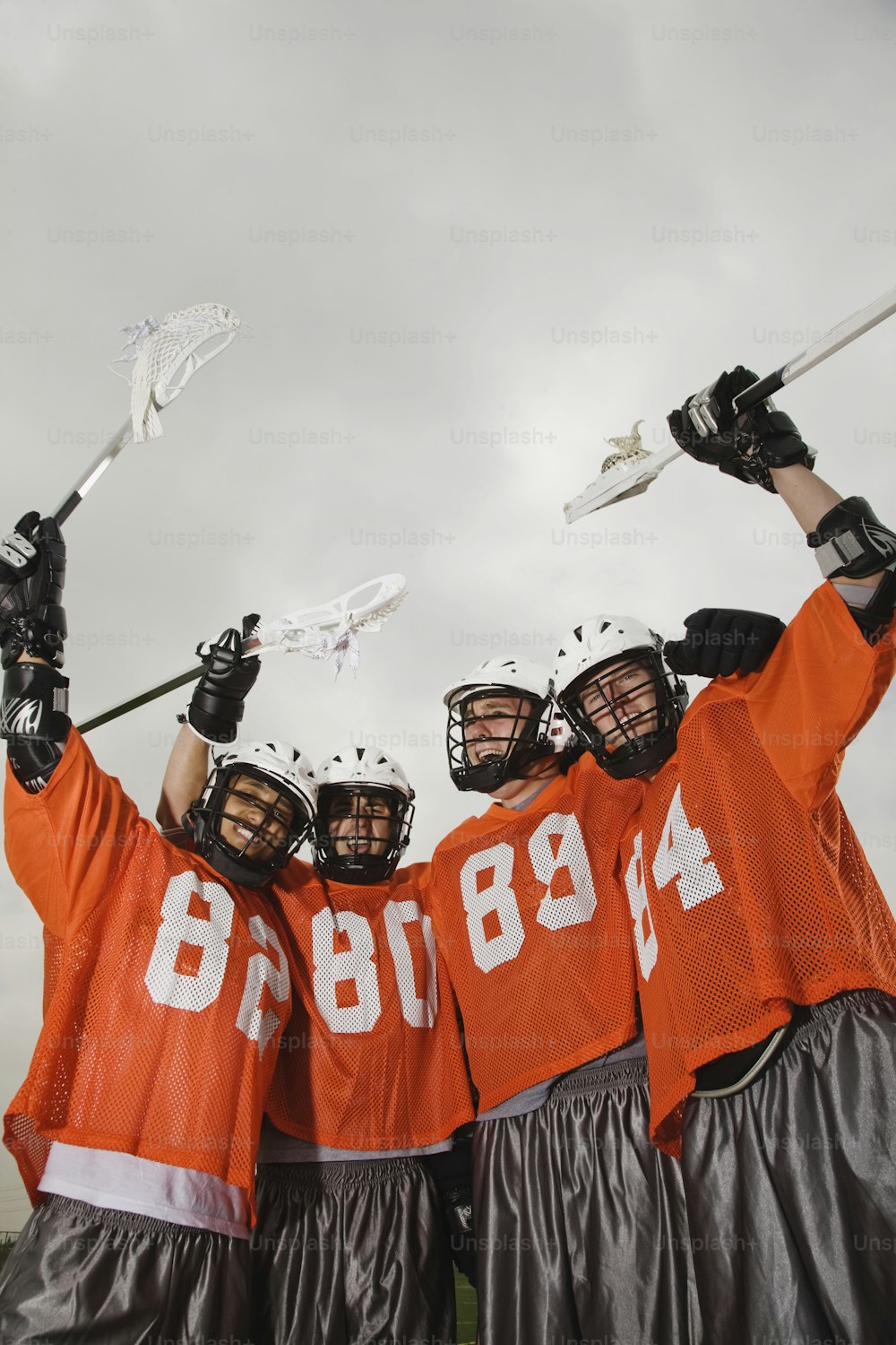 a group of lacrosse players standing next to each other