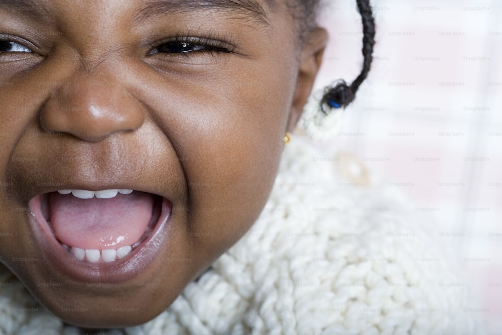 a close up of a child making a funny face