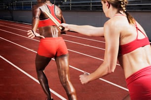 a woman in a red sports bra getting ready to run