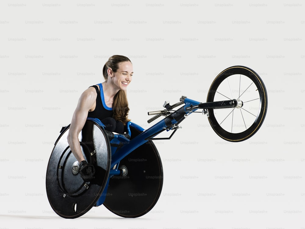 a woman in a wheel chair holding a bicycle