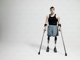 a man with crutches and a black tank top