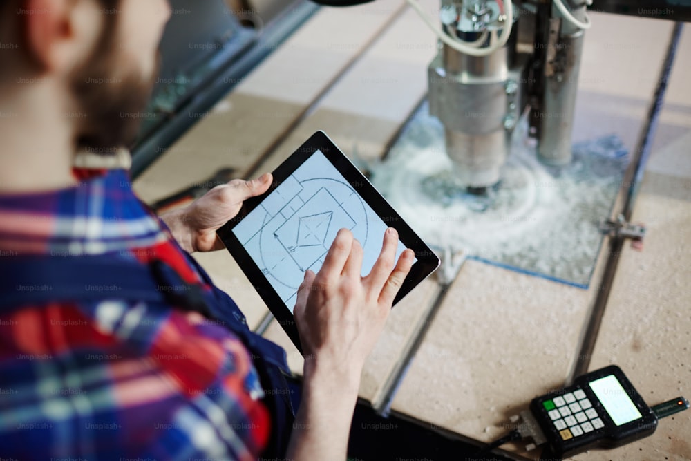 Technical sketch in touchpad held by mechanic