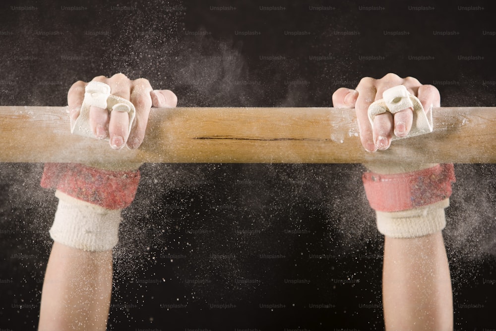 a person holding a baseball bat with powder coming out of it
