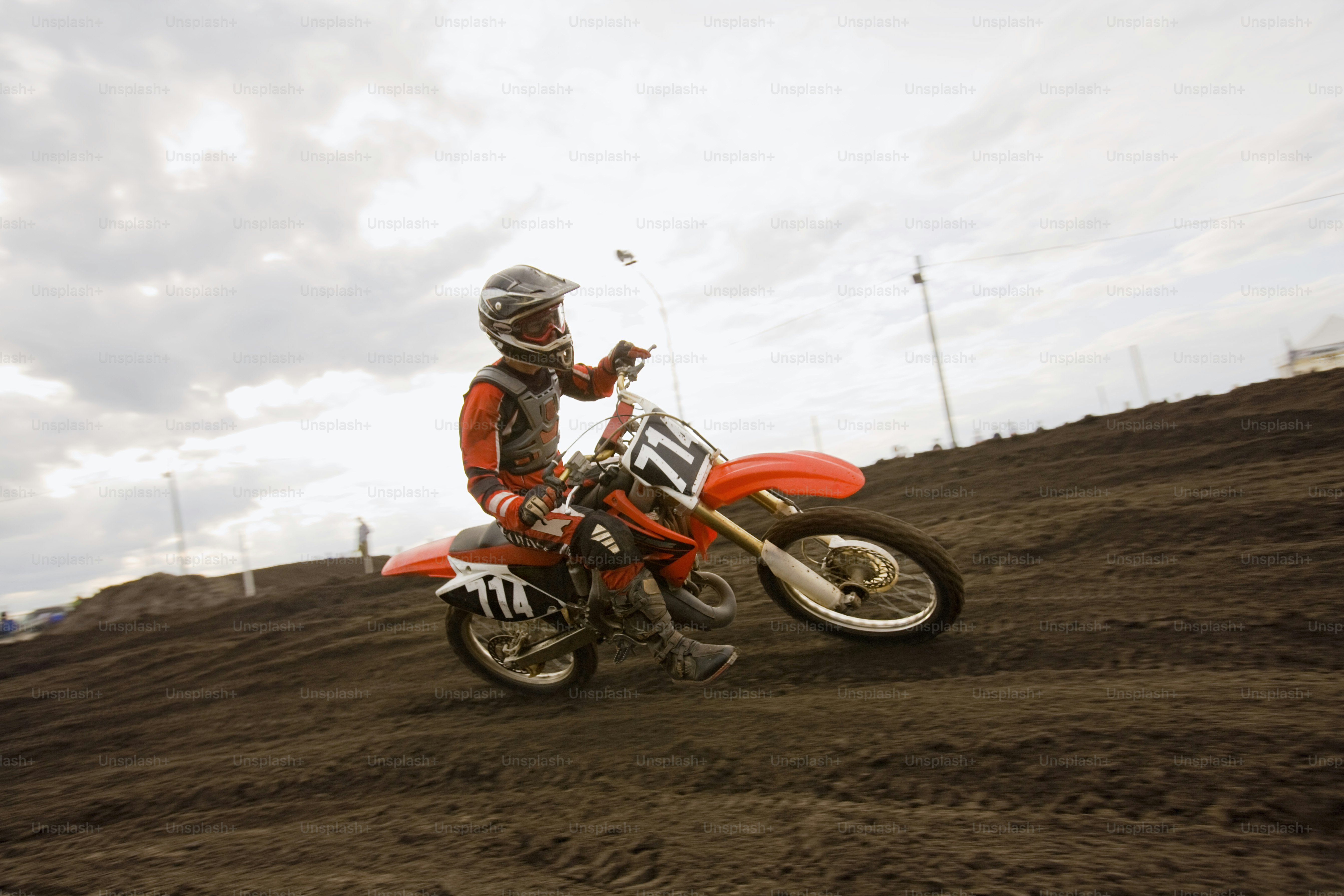 a man riding a dirt bike on top of a dirt field