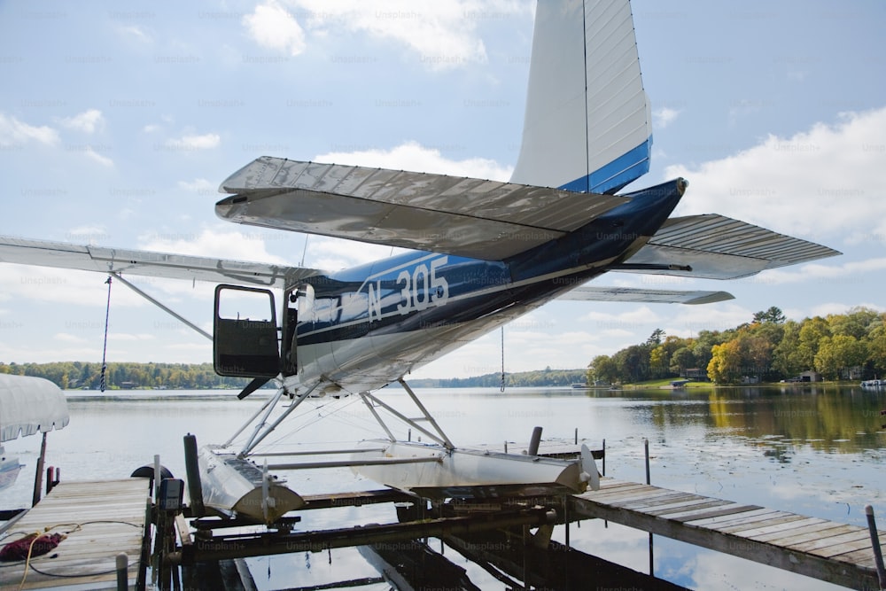 a small plane sitting on top of a wooden dock
